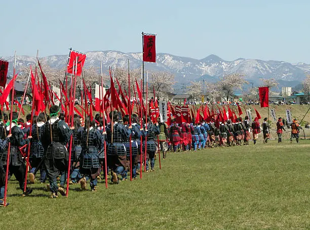 Traditional Japanese army (Takeda clan) during a  special festival in Yonezawa City (north of Japan) featuring a very famous battle between two of the most important clans in the Japanese history .The inscriptions on the flags have a historical character,they are not trademarks or adds.