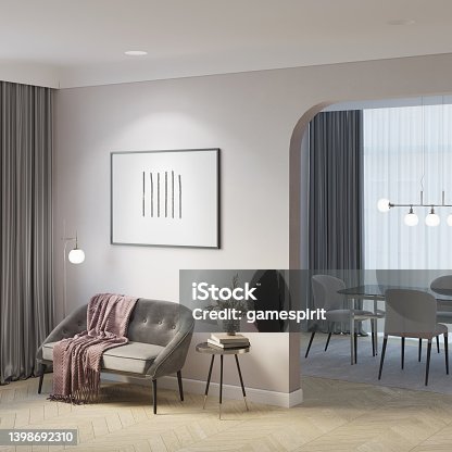 istock A cozy modern-classic room with a backlit horizontal poster, a vase of flowers on a coffee table, a floor lamp, a gray sofa by the window with curtains, an arch overlooking the dining room. 1398692310