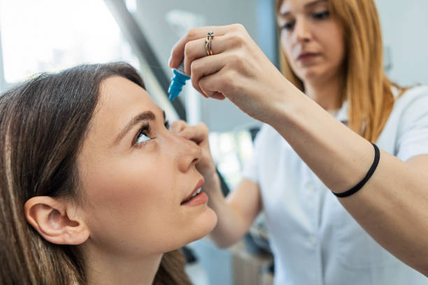 istock Ophthalmologist Using Eyedropper on a patient eye 1398693486