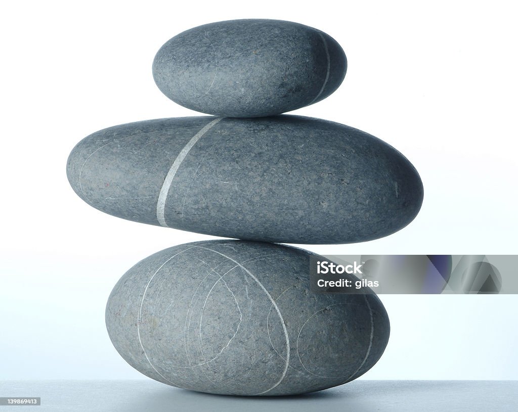 Pyramid of three stones Pyramid of three stones over white Balance Stock Photo