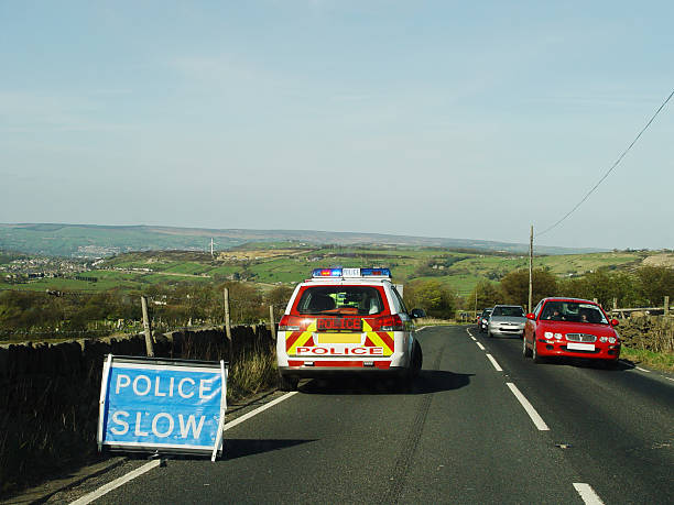 Police car and Slow sign in Landscape stock photo