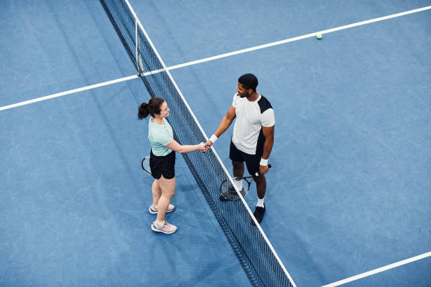 istock Young People Playing Tennis Minimal 1398695008