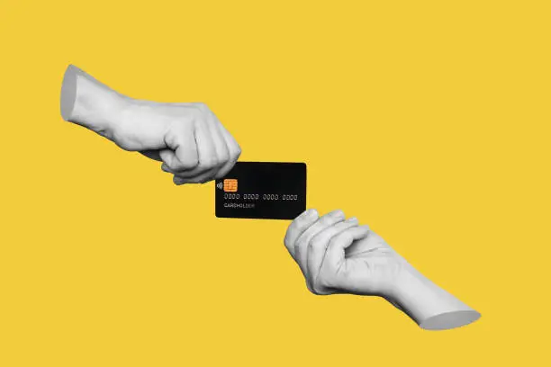 The black plastic credit card is in the hands of two women holding it from different sides isolated on a yellow background. Trendy 3d collage in magazine style. Contemporary art. Modern design