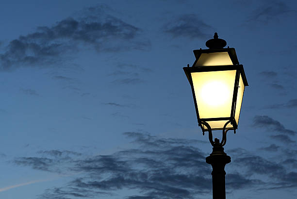 istock Lit street lamp against a cloudy dark sky 139869975
