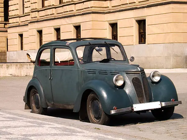 Green vintage car taken in the streets of Prague, Czech Republic. An old Skoda?