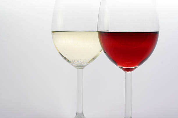 istock Two glasses half filled with red and white wine 139870212