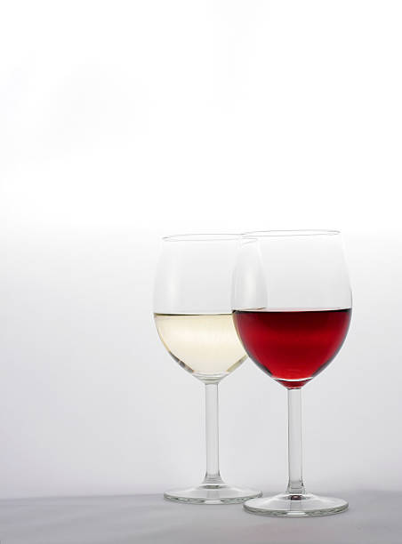 Two glasses half filled with red and white wine