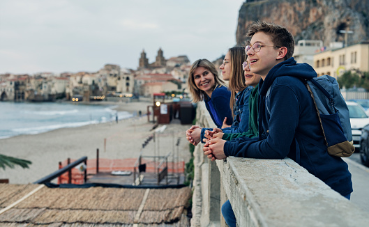 Family sightseeing beautiful Italian town of Cefalu in Sicily