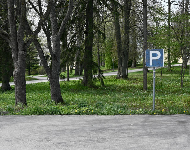 istock empty parking and parking sign, deadpan photography 1398703490