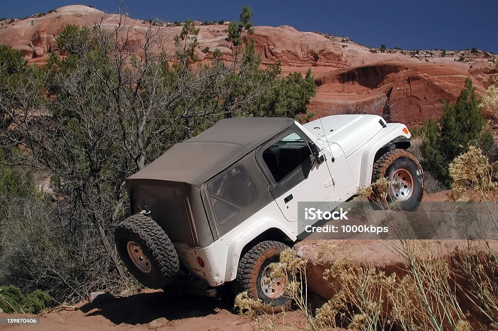 I'm not stuck. Jeep rock crawling on red rock trail near Moab, Utah. Off-Road Vehicle Stock Photo