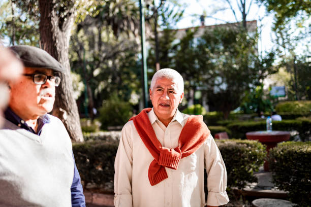 Three senior men standing on the street and talking
