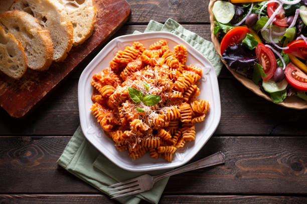 Vodka Sauce Radiatori Pasta with Homemade Vodka Sauce, Salad and Bread vodka sauce stock pictures, royalty-free photos & images