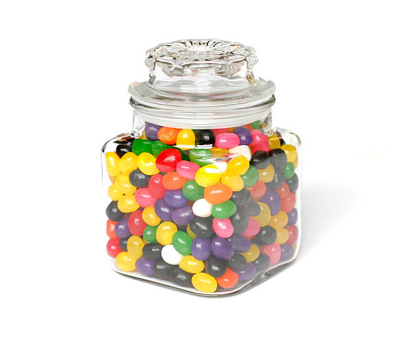 Candies in Jar Glass Jar full of multicolored candies jellybean photos stock pictures, royalty-free photos & images