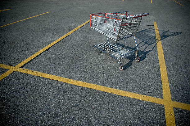 Shopping cart on a deserted parking lot. abandoned stock pictures, royalty-free photos & images
