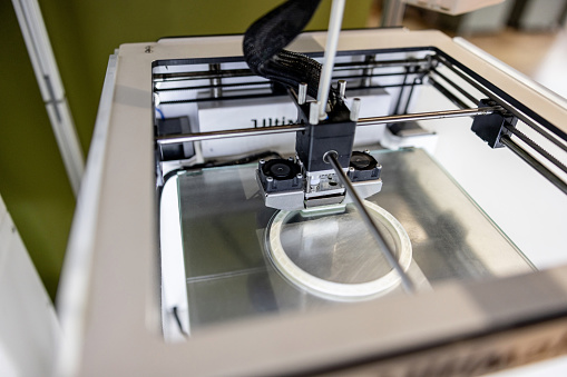 Close-up on a 3D printer printing a model - innovation concepts