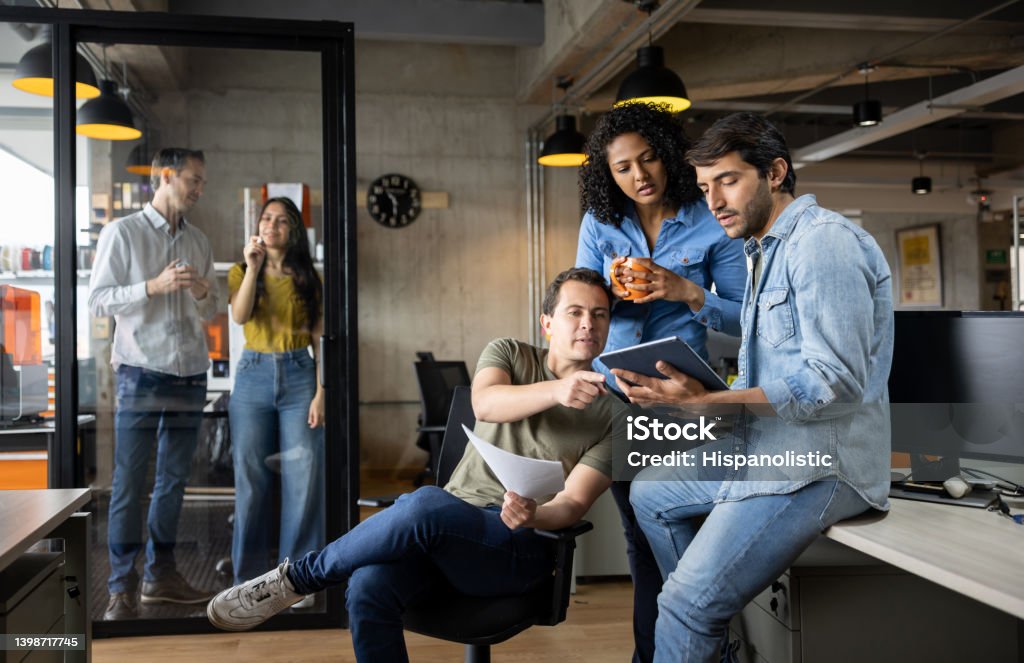 Group of workers working at a creative office Group of Latin American workers working at a creative office - new business concepts Teamwork Stock Photo