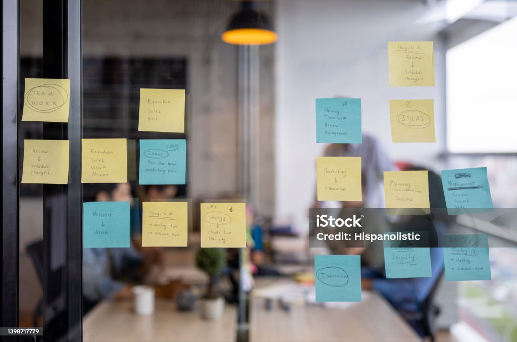 Business strategy written on a board using post its Adhesive Note Stock Photo