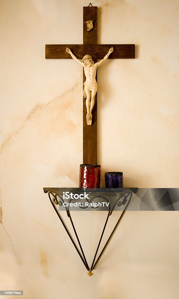 Crucifix A crucifix on the wall with some candles Alertness Stock Photo
