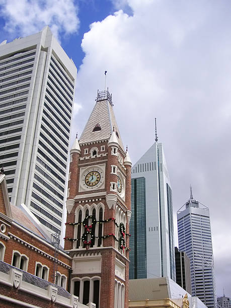 Four buildings that form part of Perth's skyline - a mix of modern and traditional architectural styles, against partly cloudy sky
