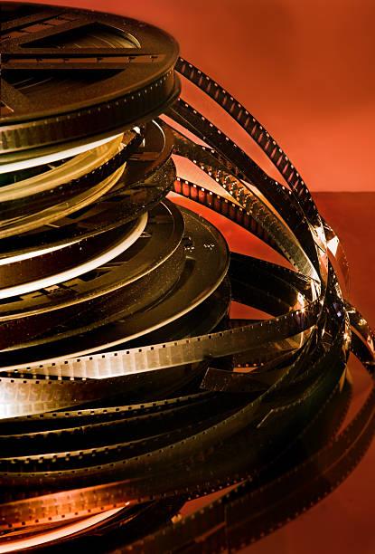 Silent movies Old and dusty film reels against a warm red background handspring stock pictures, royalty-free photos & images