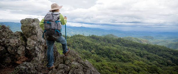 istock female hikers on top rock 1398722123