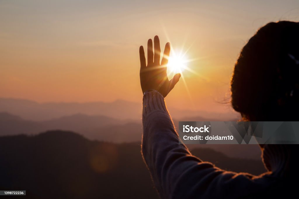 woman worship on sunset Silhouette woman on sunset background. Woman raising his hands in worship. Christian Religion concept background. Praising - Religion Stock Photo