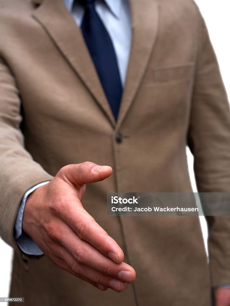 Cropped image of a business offering handshake A trendy European businessman with a blue tie and shirt. The picture is taken outdoors with a portable background.  20-24 Years Stock Photo