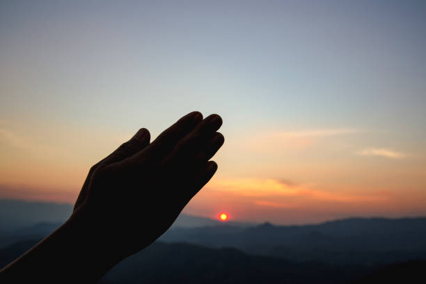istock woman worship on sunset 1398723432