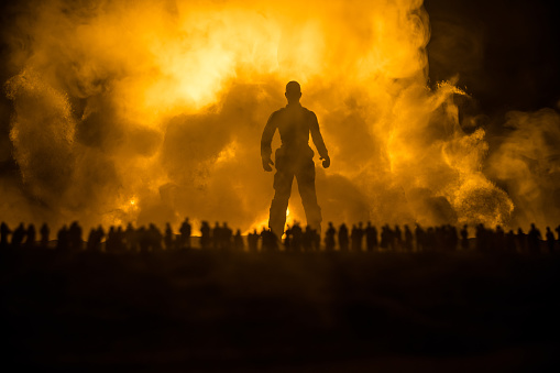 Creative artwork decoration - Russian war in Ukraine concept. Crowd looking on giant explosion and silhouette of giant person. Selective focus