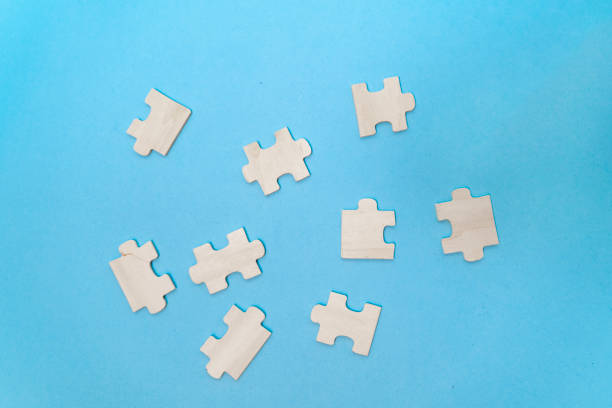 istock Top view white wooden puzzle pieces on blue paper 1398728812
