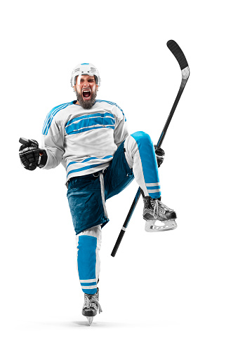 Athlete in action. Very emotional hockey player with stick and puck in his hands. Sports emotions. Hockey athlete with desire to win and be champion. Man