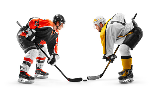 Two professional hockey players start the game. Fight for the puck. Sports emotions. Hockey concept. Isolated. Mans