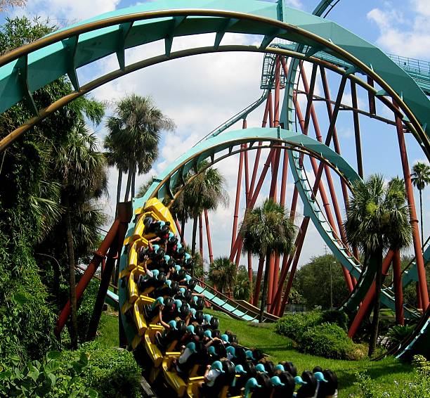 istock Close-up of roller coaster with riders in tropical setting 139873003