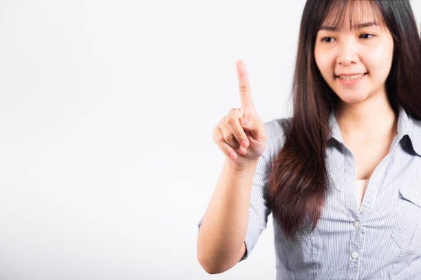 istock Woman standing her smile confidence with touching an imaginary screen with her finger 1398732119