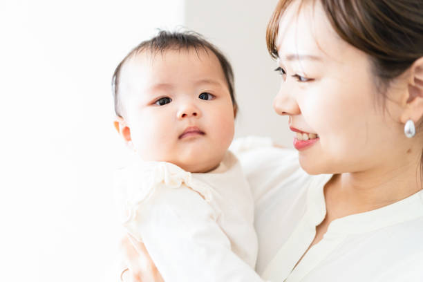 istock Young woman doing housework while carrying her baby 1398732864