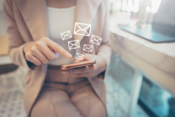 istock Email marketing concept. Woman using mobile smart phone sending online message with envelope icon 1398733916