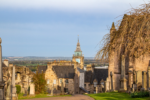 This image shows a scenic view of the cemetery grounds of the Church of The Holy Rude in Stirling, Scotland, at dusk, with gravestone dating to the 16th century.