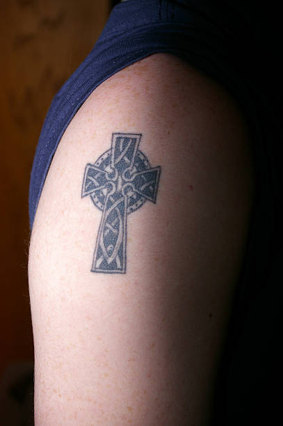 Celtic Cross Tattoo Celtic Cross tattoo on upper arm cross shoulder tattoos stock pictures, royalty-free photos & images