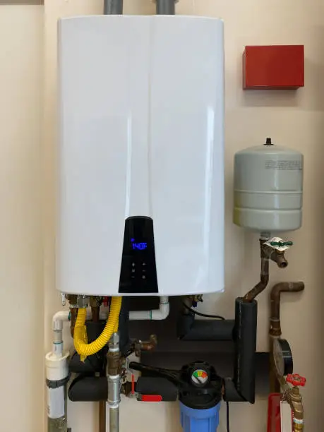 Photo of Tankless hot water heater mounted on wall of home
