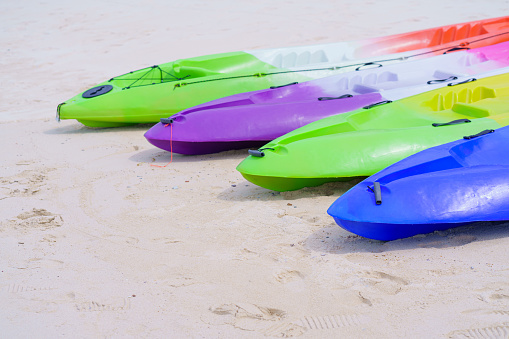 sea kayaks or multicolor boat on beautiful beach in Thailand.