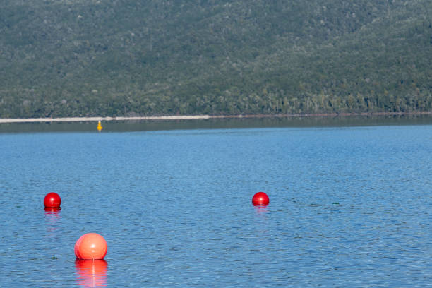 istock Thre orange buoys in triangle pattern in surface Lake Te Anau 1398741171
