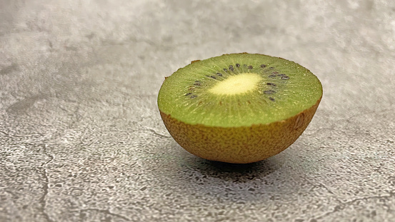 Source of vitamin C. close-up kiwi on gray background.