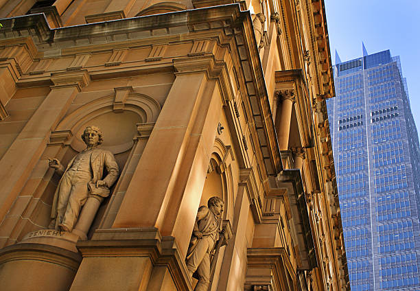Contrasting an old victorian style sandstone building with a modern skyscraper