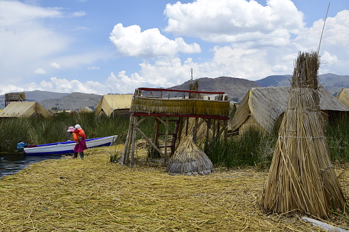 Puno, Peru - 24 january 2017: Floating islands near Puno city, Buildings and houses made of straw on the floating islands of Lake Titicaca. Puno, Peru.