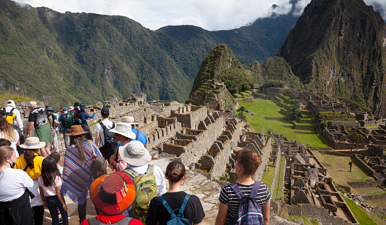 Machu Picchu - Peru,  April 2022: Tourists visiting Machu Picchu, Peru