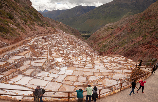 Maras, Peru, April 2022: Tourists visiting the salt Mines in Maras- Maras Salt Mines is located in the town of Maras,   in the Cusco province, in the Sacred Valley of southeastern Peru