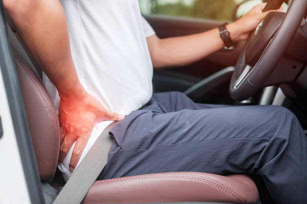 istock man with his back sprain while driving car long time, back body ache due to Piriformis Syndrome, Low Back Pain and Spinal Compression. Ergonomic and medical concept 1398747586