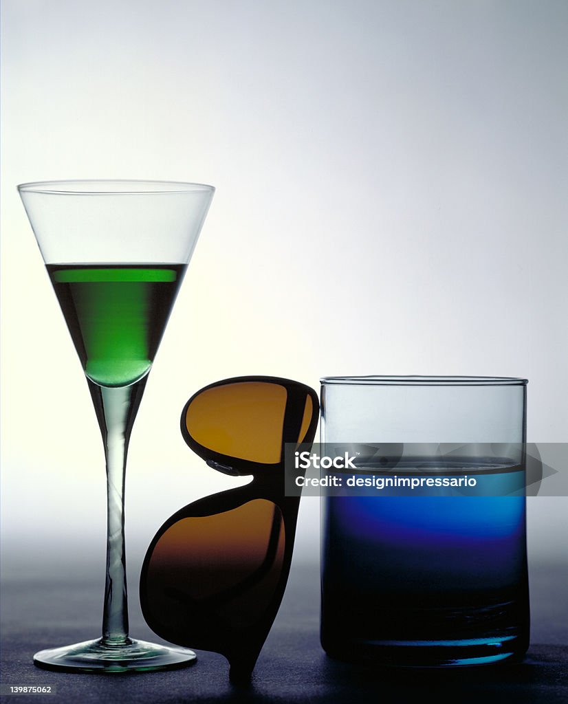 Glasses This is a still life I did as a play on words. I really like the way the back lighting makes the colored liquid in the glasses glow. Back Lit Stock Photo