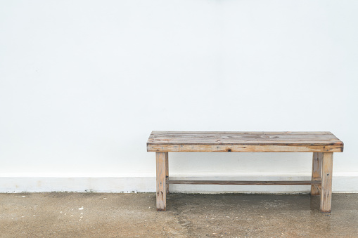 Wooden bench and white wall background