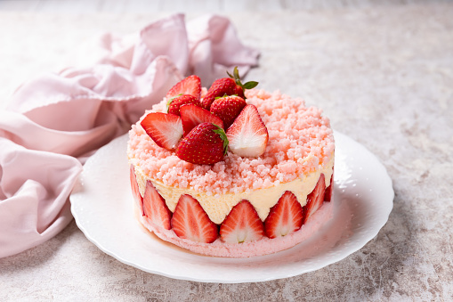 Chocolate cake with various berries and rose on wooden table